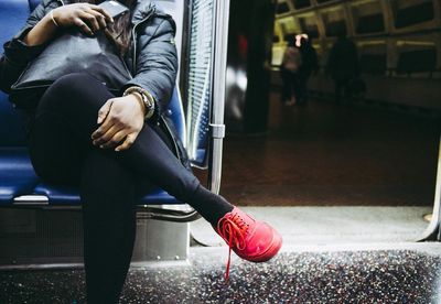 Low section of woman sitting on floor