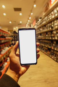 Cropped hands of woman using mobile phone