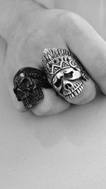 Cropped image of man with skull rings on table