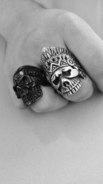 Cropped image of man with skull rings on table