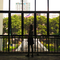 Woman standing by window