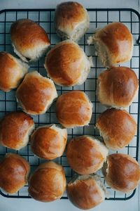 Directly above of fresh baked sweet buns on baking tray