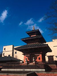 Low angle view of temple building against blue sky