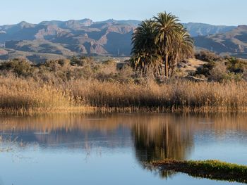 Scenic view of lake and mountains against sky