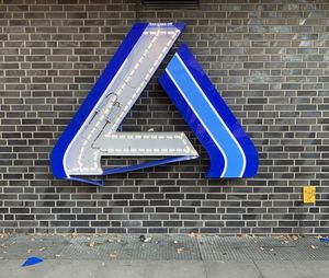 Low angle view of blue sign on wall