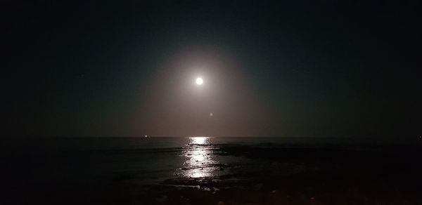 Scenic view of sea against sky at night