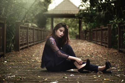 Full length of woman sitting outdoors