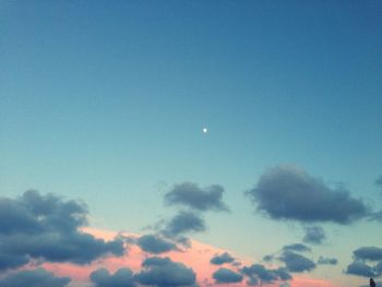 Low angle view of moon in blue sky