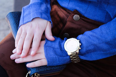 Midsection of woman with clutch bag