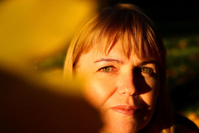 Close-up portrait face of young caucasian blonde woman in autumn. bright stylish woman in abstract 