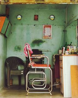 Rear view of man standing on table against wall