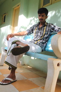 Portrait of young man sitting at home