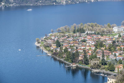 Aerial view of townscape by sea against sky