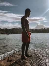 Man looking at sea against sky