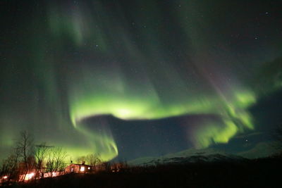 Low angle view of illuminated lights in sky at night