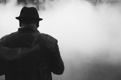 Rear view of man standing against back drop