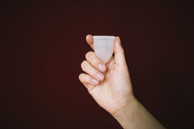 Female hand holding menstrual cup