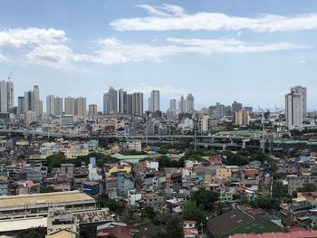 Aerial view of modern buildings in city against sky