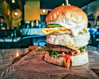 Close-up of burger on paper at restaurant