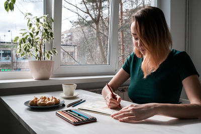 Midsection of woman preparing food at home