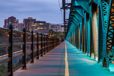 Blurred motion of person walking on bridge during sunset