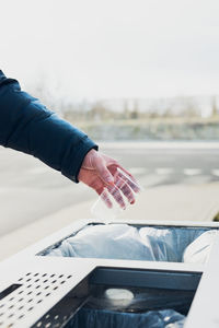 Man throwing a plastic cup to trash. plastic waste to recycling. concept of plastic pollution