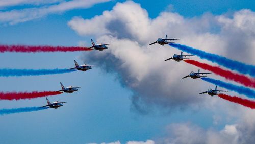 Low angle view of airshow against sky