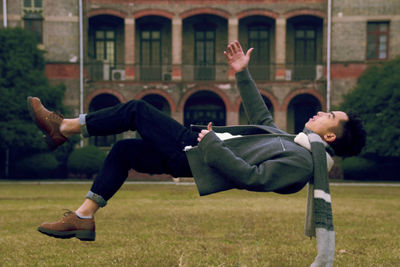 Man lying above grass