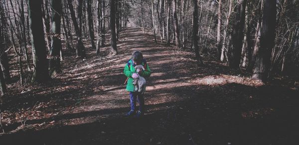 Boy standing in forest