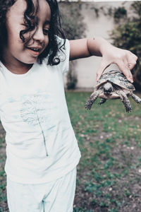 Midsection of girl holding horse