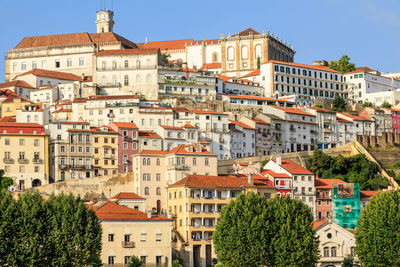 Buildings in city against clear sky