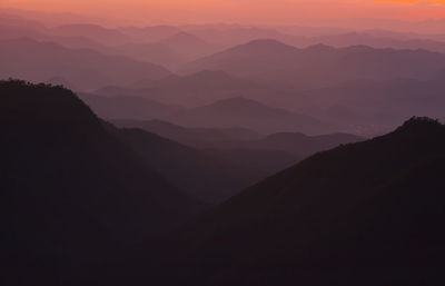 Scenic view of silhouette mountains against sky during sunset