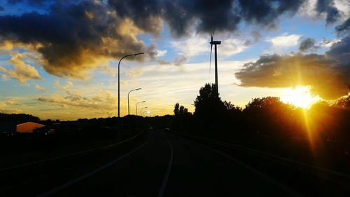 Road against cloudy sky at sunset