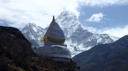 Statue of buddha against mountain range