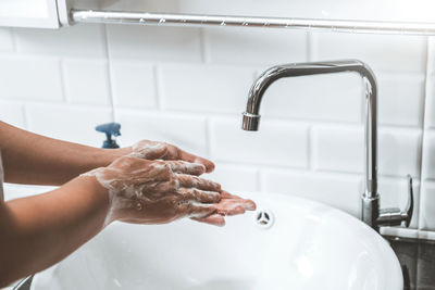 Midsection of woman in bathroom at home