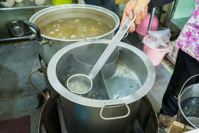 Midsection of man preparing food in kitchen