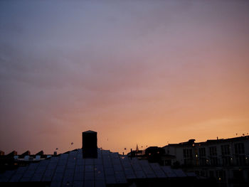 Exterior of buildings against sky at sunset