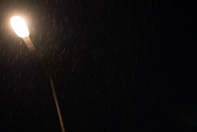 Low angle view of illuminated street light at night