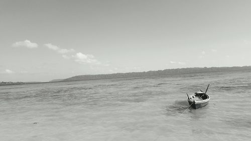 Man surfing in sea against sky