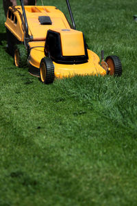 High angle view of lawn mower on grassy field