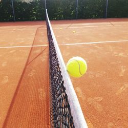 High angle view of tennis ball by net on court