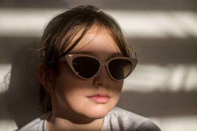 Close-up portrait of young woman wearing sunglasses