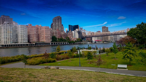 River in city against blue sky