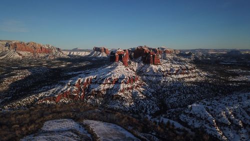 Scenic view of rock formations in desert during winter at sunset