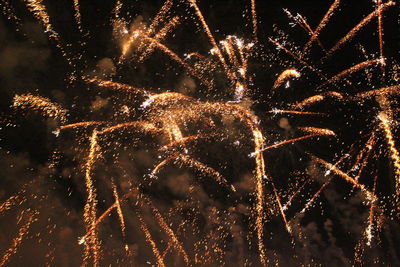 Low angle view of firework display at night
