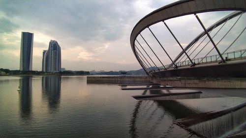 Bridge over river with city in background