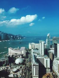 Aerial view of city against cloudy sky