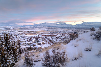 Scenic view of snowcapped mountains against sky during sunset