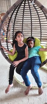 Full length portrait of friends sitting outdoors