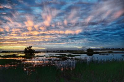 Scenic view of lake against sky during sunset